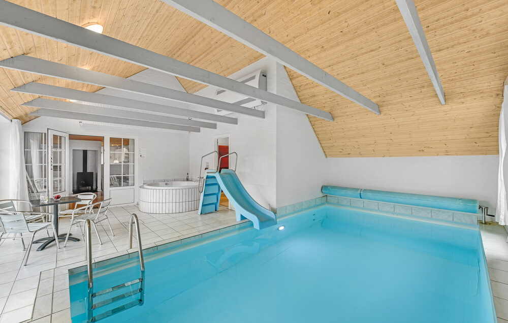 Sommarstuga 145 är inredd med en smakfull poolavdelning som har vattenrutschbana, ett stort inbyggt spapad och bastu