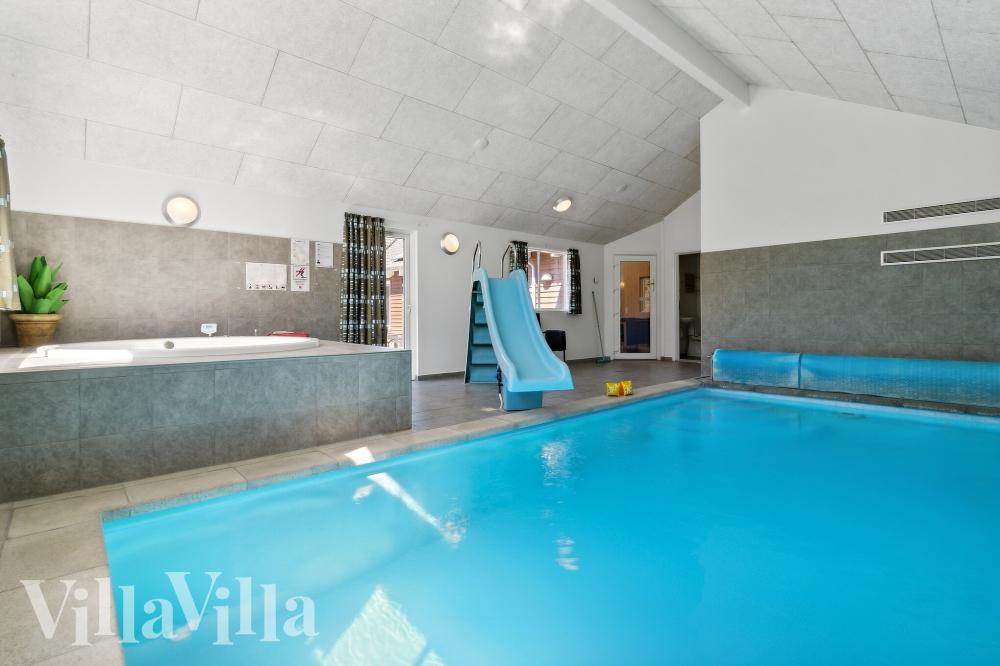Sommarstuga 261 är inredd med en smakfull poolavdelning som har vattenrutschbana, ett stort inbyggt spapad och bastu
